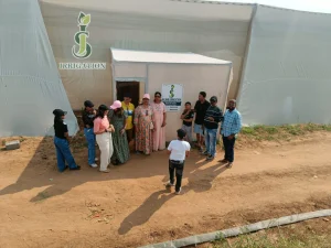 Visitors Outside Polyhouse Site Office